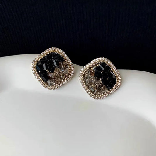 Model showcasing the dangle and style of the 14K Gold-Plated Elegant Black Crystal Zircon Stud Earrings