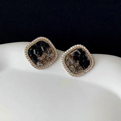 Model showcasing the dangle and style of the 14K Gold-Plated Elegant Black Crystal Zircon Stud Earrings