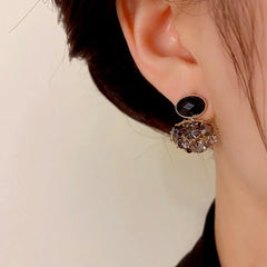 Close-up detail of the sparkling zircons and plating on the Black Oval Earrings