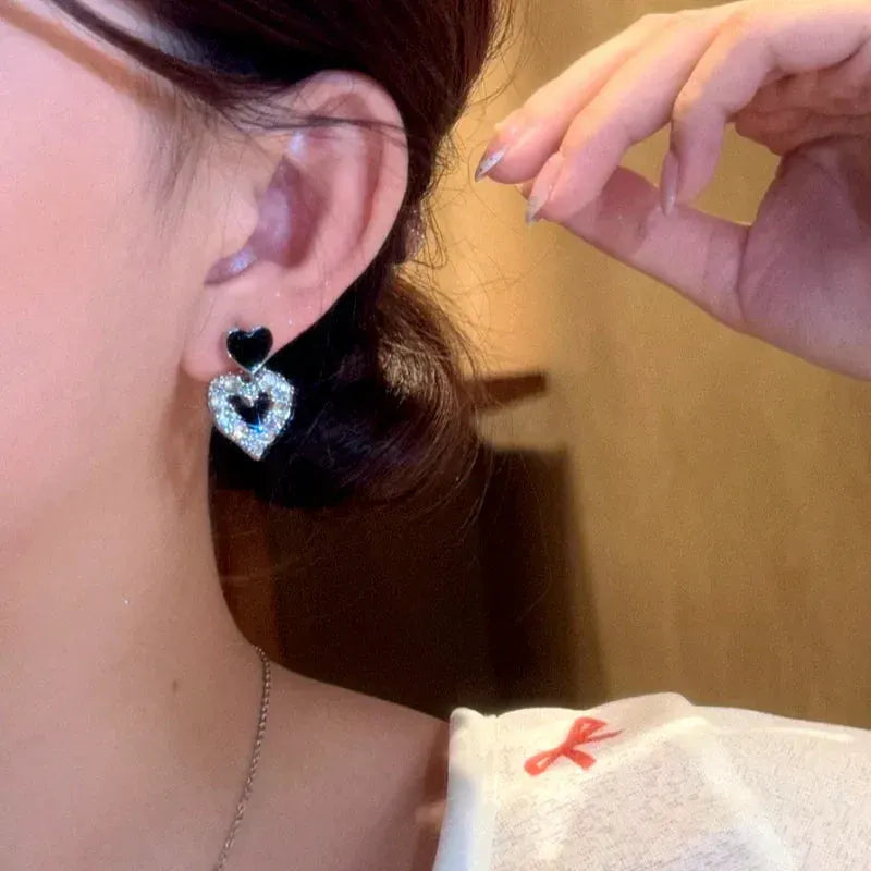 Angled view of the 14K Gold-Plated Elegant Bling Bling Heart Earrings