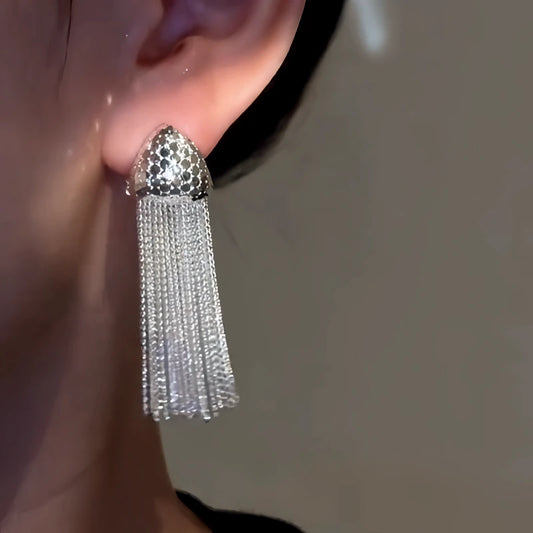 Model showcasing the dangle and style of the 14K Gold-Plated Elegant Bling Tassel Earrings