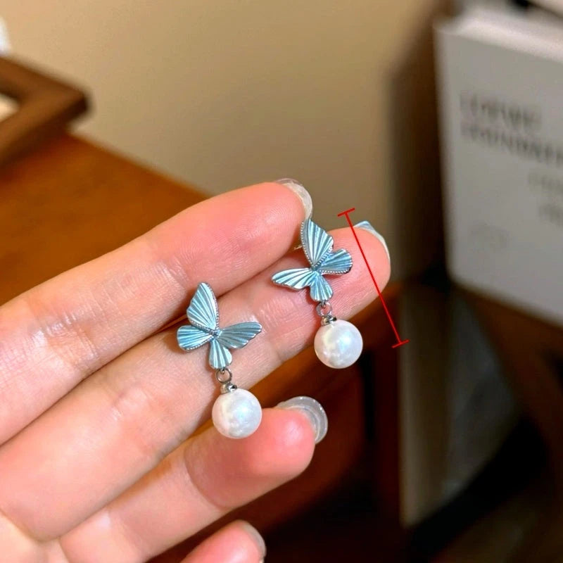 Angled view of the 14K Gold-Plated Elegant Blue Butterfly Pearl Earrings