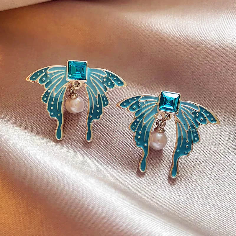 Angled view of the 14K Gold-Plated Elegant Blue Butterfly Pearl Earrings