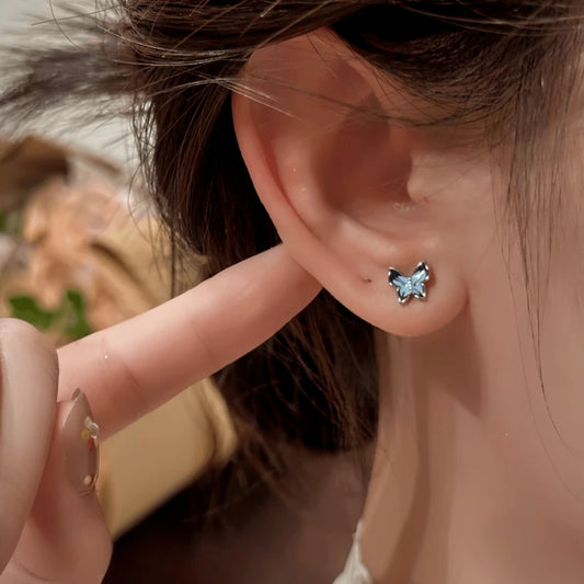 Model showcasing the dangle and style of the 14K Gold-Plated Elegant Blue Butterfly Stud Earrings