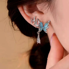 Model showcasing the dangle and style of the 14K Gold-Plated Elegant Blue Butterfly Zircon Water Drop Earrings