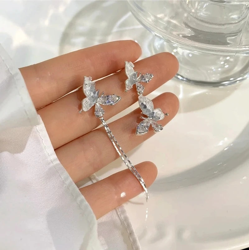 Angled view of the 14K Gold-Plated Elegant Blue Crystal Butterfly Earrings