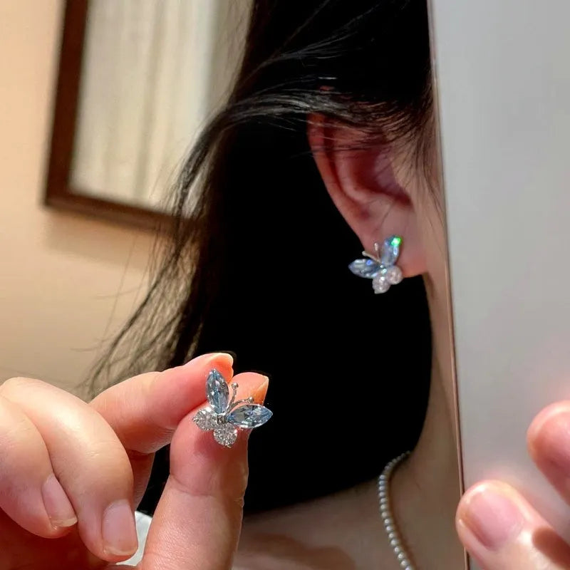 Angled view of the 14K Gold-Plated Elegant Blue Crystal Butterfly Stud Earrings