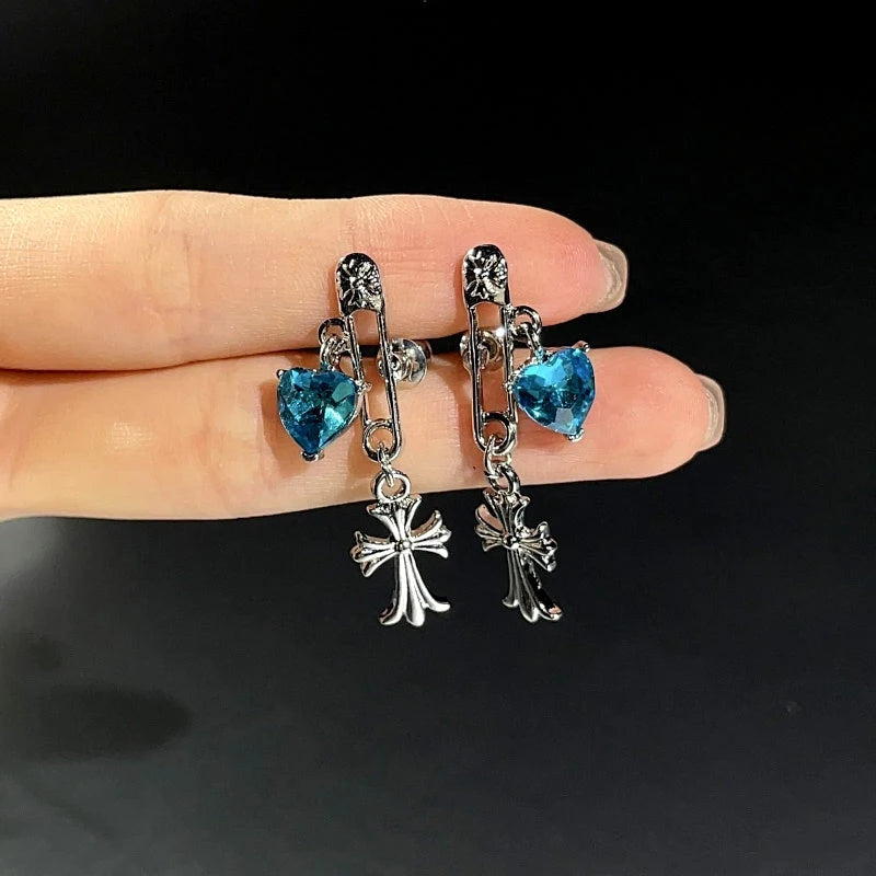 Angled view of the 14K Gold-Plated Elegant Blue Diamond Heart Cross Pin Earrings