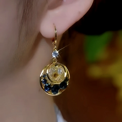 Model showcasing the dangle and style of the 14K Gold-Plated Elegant Blue Diamond Mesh Water Drop Earrings