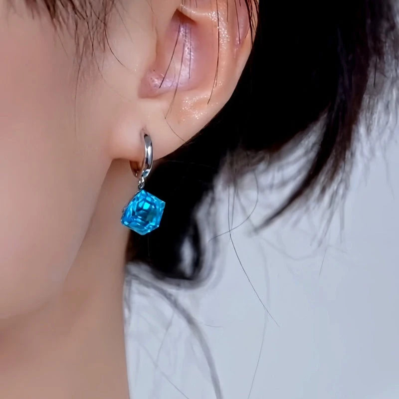 Model showcasing the dangle and style of the 14K Gold-Plated Elegant Blue Zircon Diamond Earrings