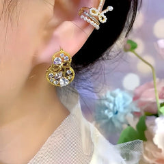 Model showcasing the dangle and style of the 14K Gold-Plated Elegant Bow Hollow Gourd Earrings