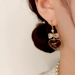 Close-up detail of the sparkling zircons and plating on the Leopard Heart Earrings