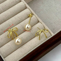 Close-up detail of the sparkling zircons and plating on the Bow Pearl Earrings