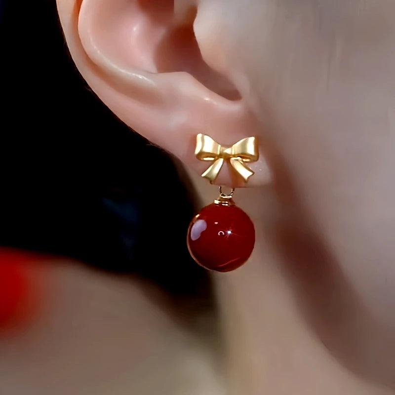 Close-up detail of the sparkling zircons and plating on the Bow Red Bead Earrings