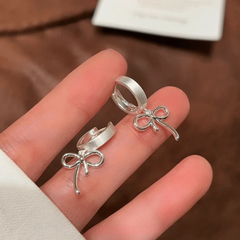 Angled view of the 14K Gold-Plated Elegant Bow Tassel Earrings