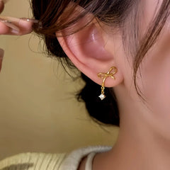 Model showcasing the dangle and style of the 14K Gold-Plated Elegant Bow Zircon Water Drop Earrings