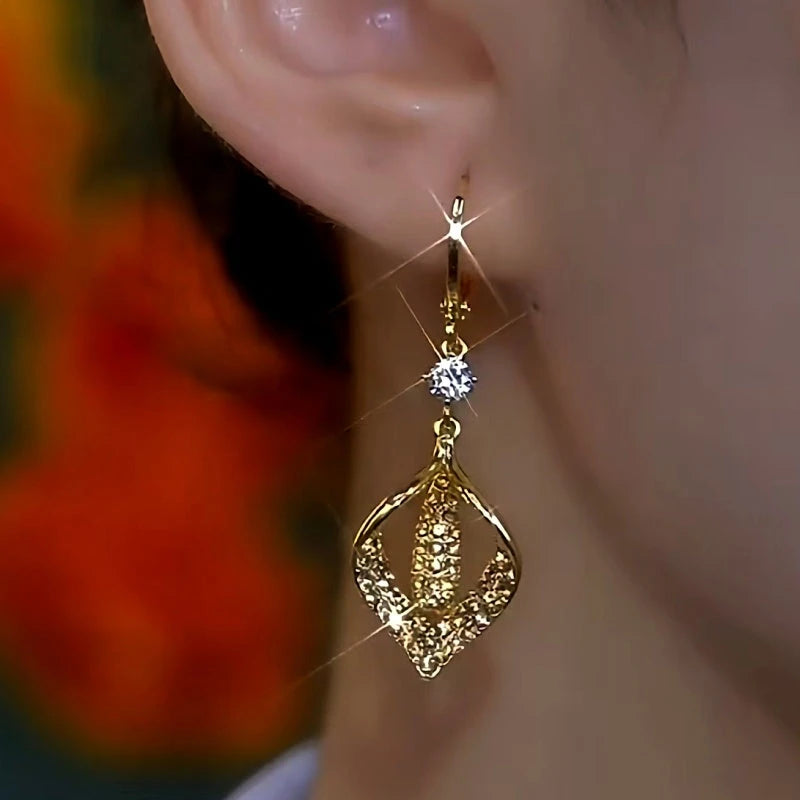 Model showcasing the dangle and style of the 14K Gold-Plated Elegant Brown Diamond Geometric Earrings