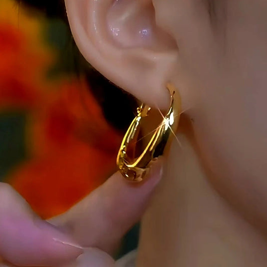 Model showcasing the dangle and style of the 14K Gold-Plated Elegant Brown Diamond Hoop Earrings