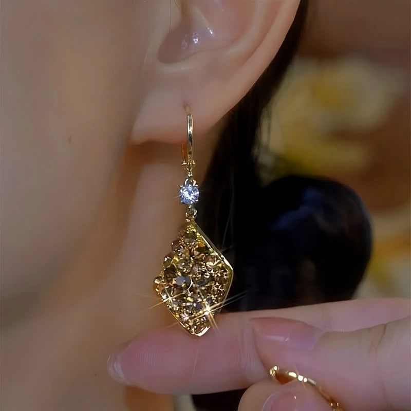 Model showcasing the dangle and style of the 14K Gold-Plated Elegant Brown Zircon Daimond Water Drop Earrings