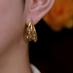 Model showcasing the dangle and style of the 14K Gold-Plated Elegant Brown Zircon Diamond Hoop Earrings
