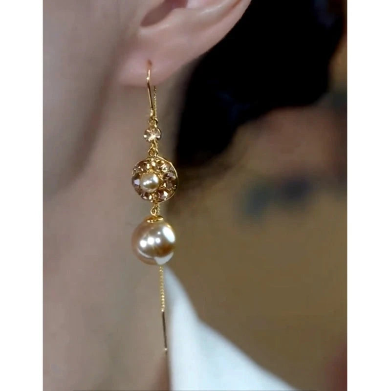 Model showcasing the dangle and style of the 14K Gold-Plated Elegant Brown Zircon Diamond Pearl Threader Earrings