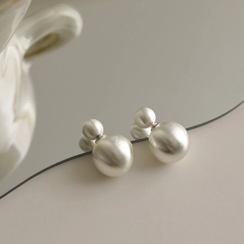 Close-up detail of the sparkling zircons and plating on the Brushed Ball Earrings