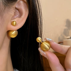Angled view of the 14K Gold-Plated Elegant Brushed Ball Earrings