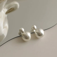 Close-up detail of the sparkling zircons and plating on the Brushed Ball Earrings