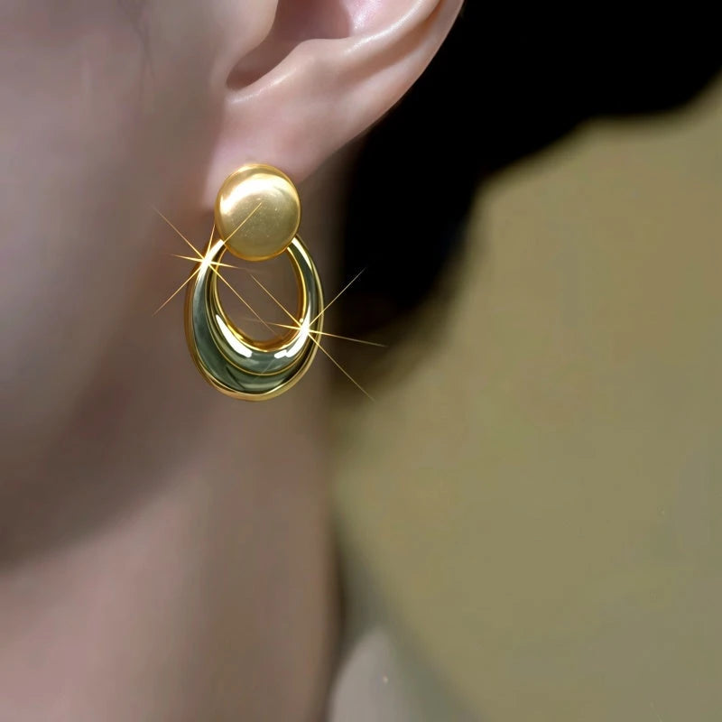 Close-up detail of the sparkling zircons and plating on the Brushed Oval Earrings