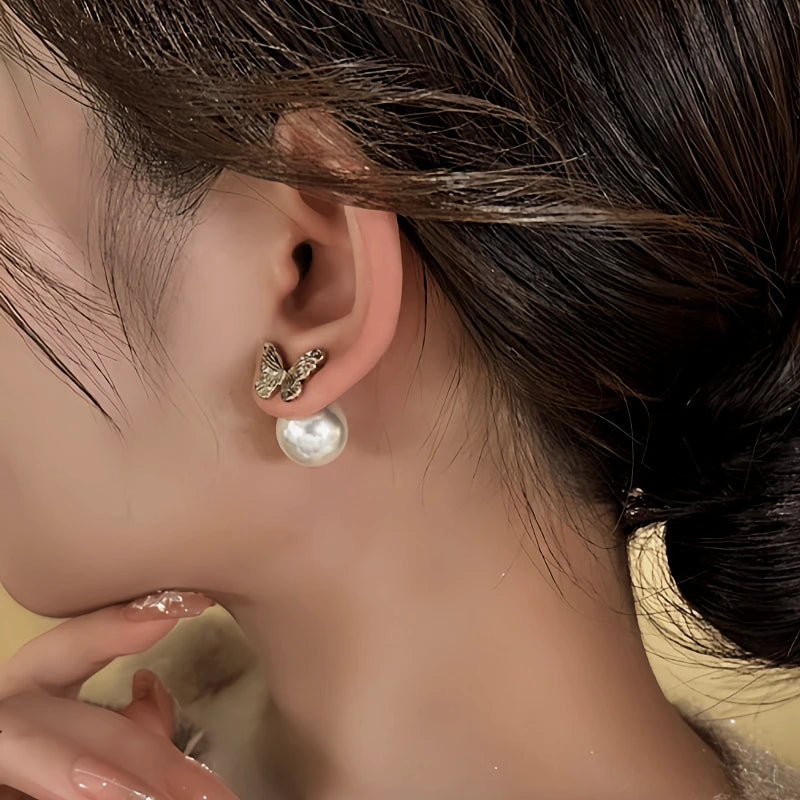 Model showcasing the dangle and style of the 14K Gold-Plated Elegant Butterfly Bead Earrings