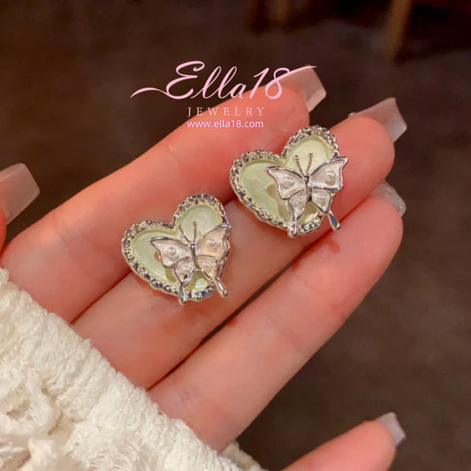 Model showcasing the dangle and style of the 14K Gold-Plated Elegant Butterfly Heart Earrings