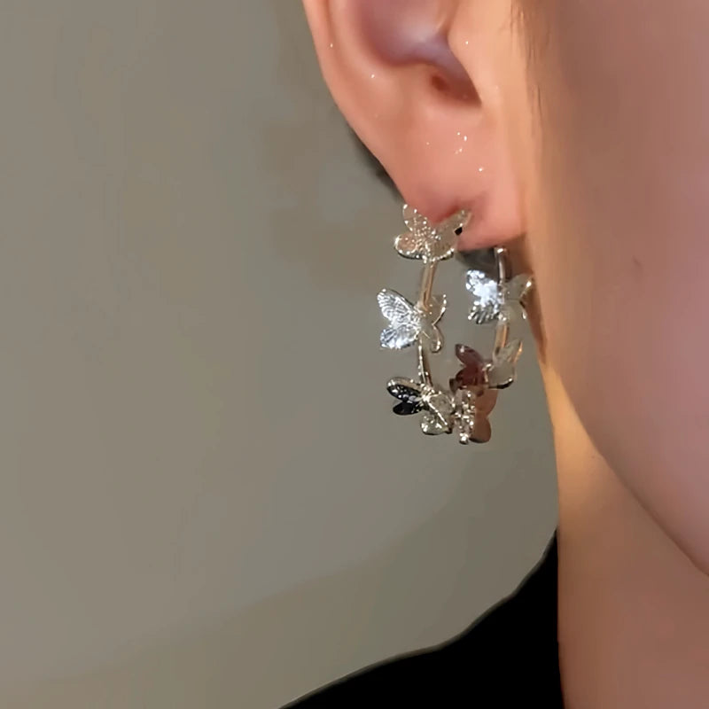 Model showcasing the dangle and style of the 14K Gold-Plated Elegant Butterfly Hoop Earrings