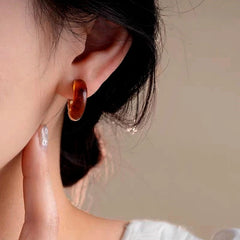 Close-up detail of the sparkling zircons and plating on the C-Ring Earrings