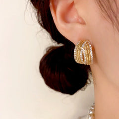 Model showcasing the dangle and style of the 14K Gold-Plated Elegant C-Shaped Diamond Earrings