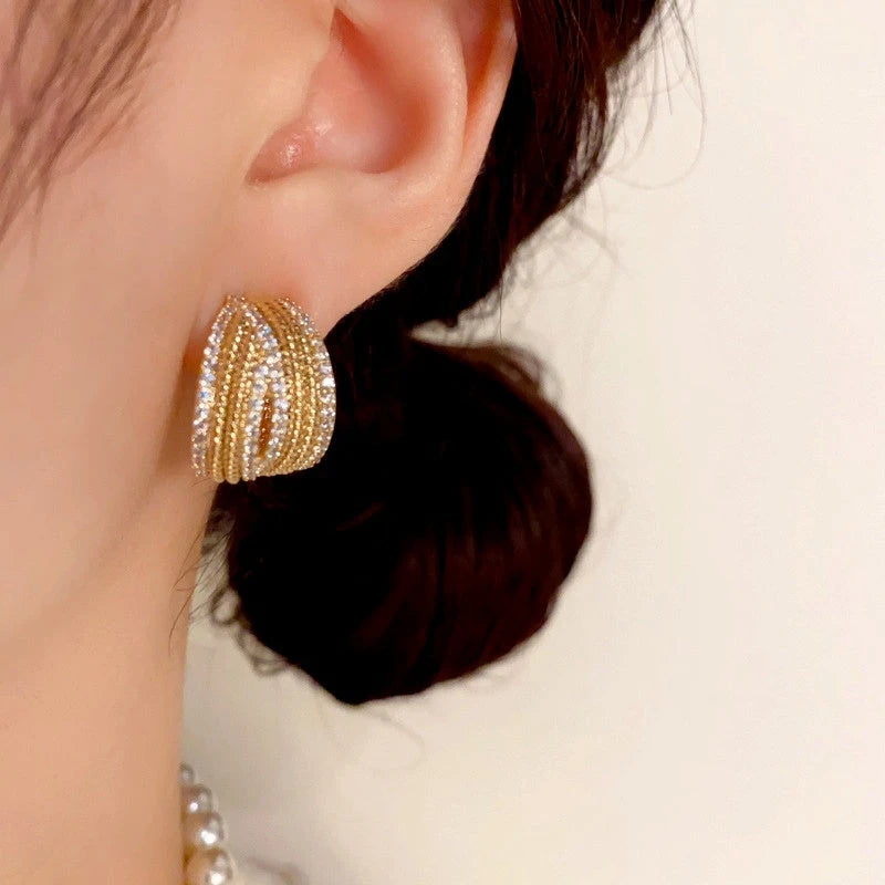 Close-up detail of the sparkling zircons and plating on the C-Shaped Diamond Earrings