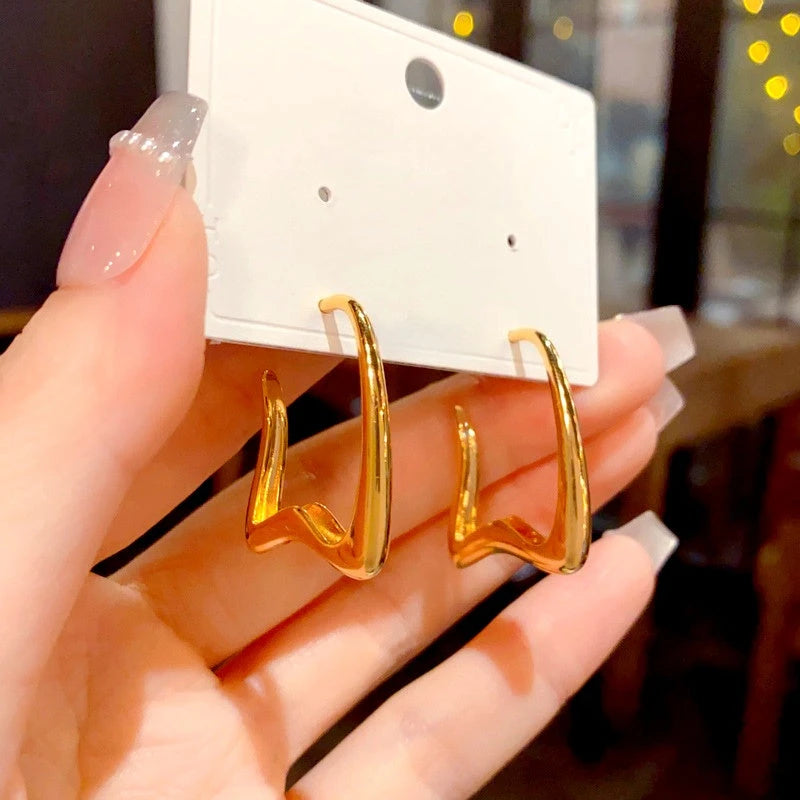 Close-up detail of the sparkling zircons and plating on the C-Shaped Drop Earrings