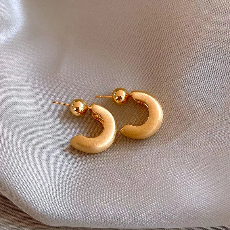 Close-up detail of the sparkling zircons and plating on the C-Shaped Hoop Earrings