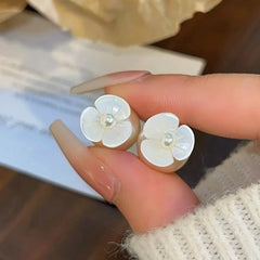 Model showcasing the dangle and style of the 14K Gold-Plated Elegant Camellia Bead Earrings