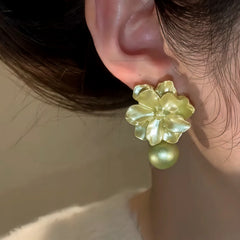 Close-up detail of the sparkling zircons and plating on the Camellia Pearl Earrings