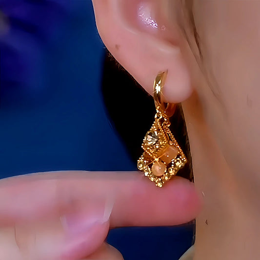 Model showcasing the dangle and style of the 14K Gold-Plated Elegant Cat's Eye Diamond Earrings