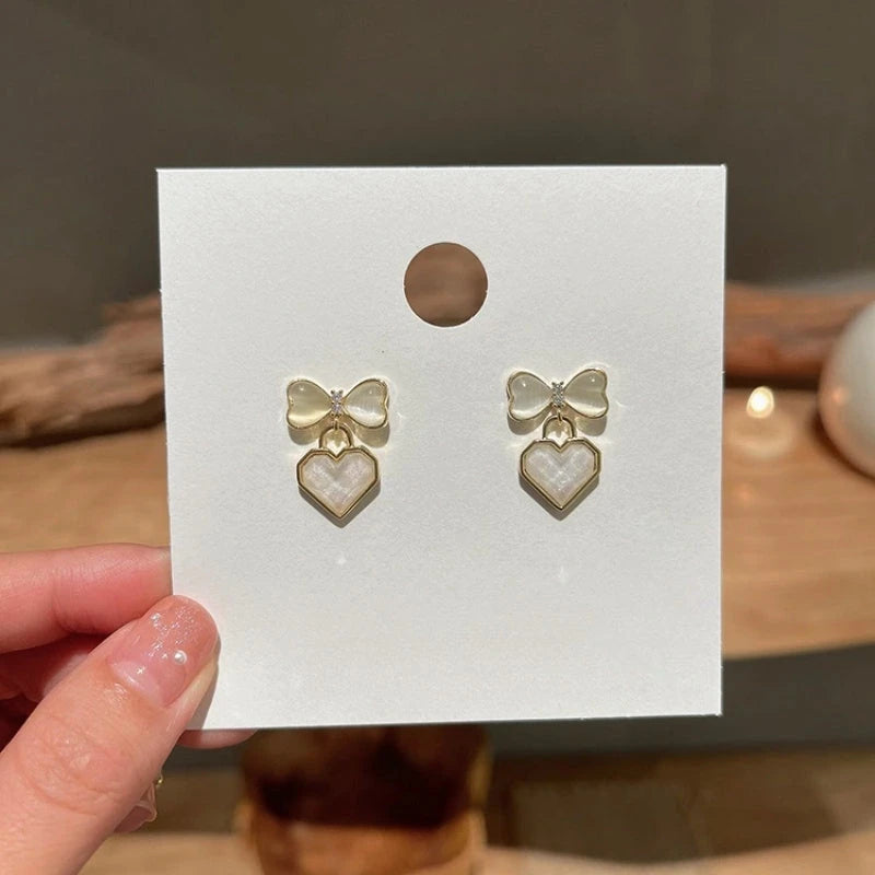 Close-up detail of the sparkling zircons and plating on the Heart Bow Earrings