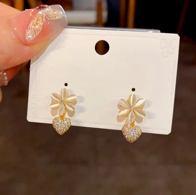 Close-up detail of the sparkling zircons and plating on the Cat's Eye Heart Earrings