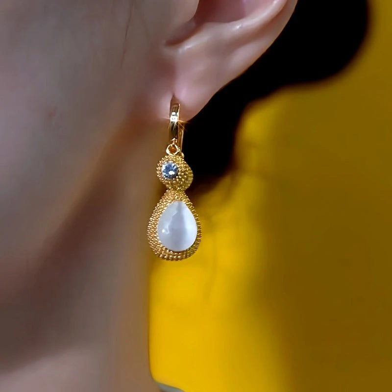 Close-up detail of the sparkling zircons and plating on the Tassel Earrings