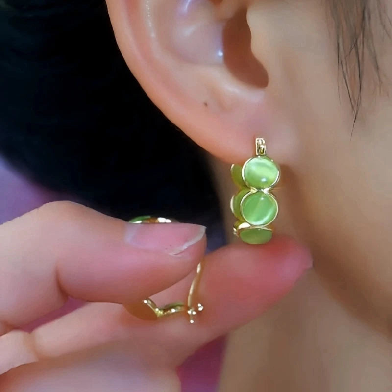 Close-up detail of the sparkling zircons and plating on the Cat's Eye Hoop Earrings