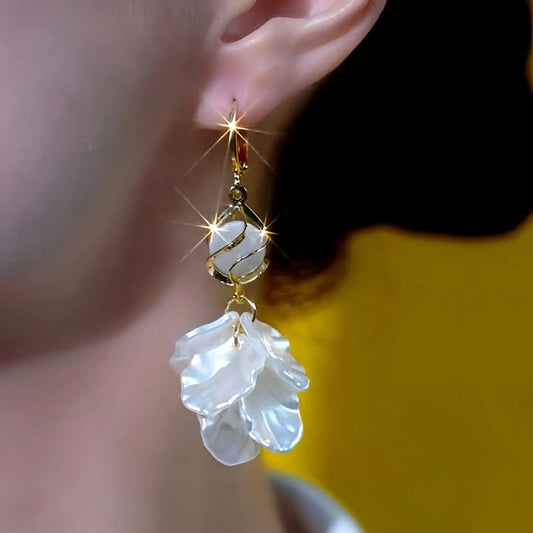 Model showcasing the dangle and style of the 14K Gold-Plated Elegant Cat's Eye Stone Shell Tassel Earrings