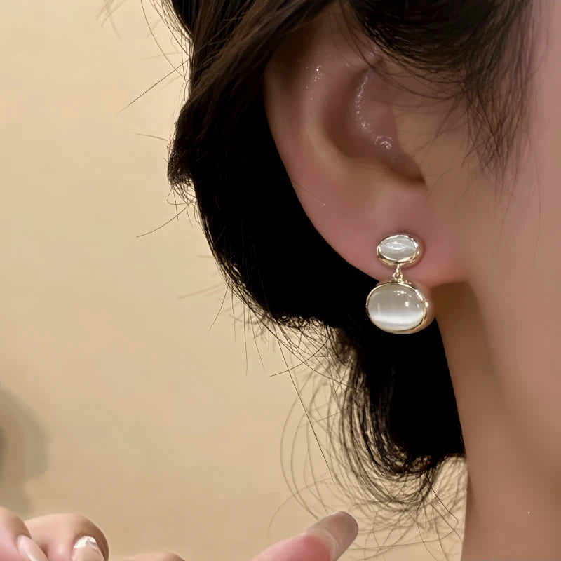 Close-up detail of the sparkling zircons and plating on the Cat's Eye Water Drop Earrings