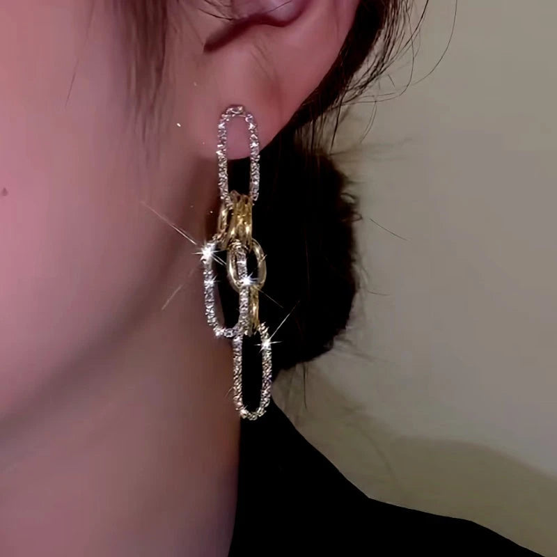 Model showcasing the dangle and style of the 14K Gold-Plated Elegant Chain Tassel Earrings