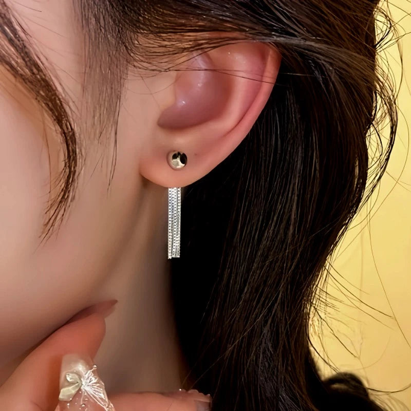 Close-up detail of the sparkling zircons and plating on the Chain Tassel Ear Jackets