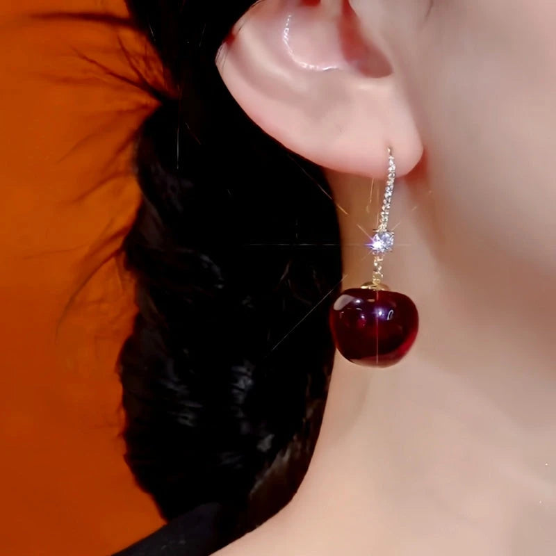 Model showcasing the dangle and style of the 14K Gold-Plated Elegant Cherry 馃崚 Ear Hook Earrings