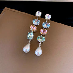 Model showcasing the dangle and style of the 14K Gold-Plated Elegant Colorful Diamond Pearl Tassel Earrings
